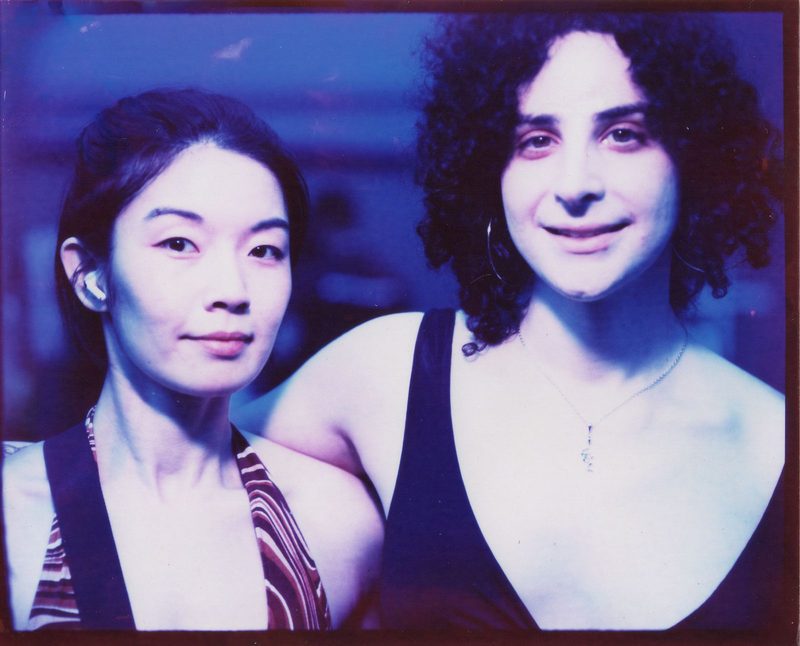Two friends in a blue-toned color portrait made at Fremont Fridays